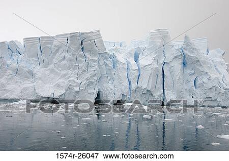 Reflection of an iceberg in water View Large Photo Image Stock Photo - Reflection of an iceberg in water. Fotosearch