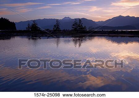 Stock Photo - Reflection of clouds and mountains in water, Hood Canal, Olympic Mountains, Washington, USA. Fotosearch