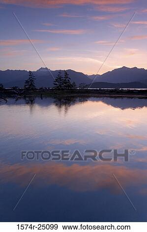 Reflection of clouds and mountains in water, Hood Canal, Olympic Mountains, Washington, USA View Large Photo Image Stock Photo - Reflection of clouds and mountains in water, Hood Canal, Olympic Mountains, Washington, USA. Fotosearch
