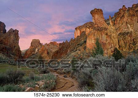 Stock Image - Rock formations on a landscape, Leslie Gulch, Oregon, USA. Fotosearch