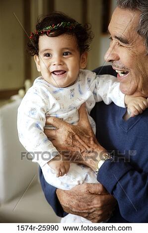 Senior man holding his great-grandchild and laughing View Large Photo Image Stock Image - Senior man holding his great-grandchild and laughing. Fotosearch