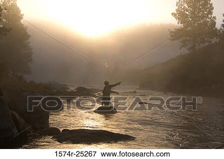 Silhouette of a person fly-fishing in a lake View Large Photo Image Stock Photo - Silhouette of a person fly-fishing in a lake. Fotosearch
