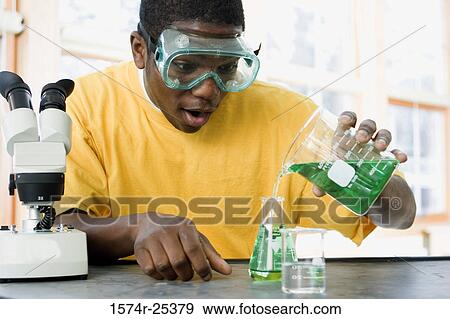 Student pouring liquid in to a beaker in a science lab View Large Photo Image Stock Photo - Student pouring liquid in to a beaker in a science lab. Fotosearch