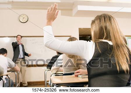 Student raising her hand in a classroom View Large Photo Image Stock Photograph - Student raising her hand in a classroom. Fotosearch