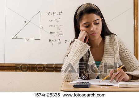 Student sitting at a desk View Large Photo Image Stock Photography - Student sitting at a desk. Fotosearch