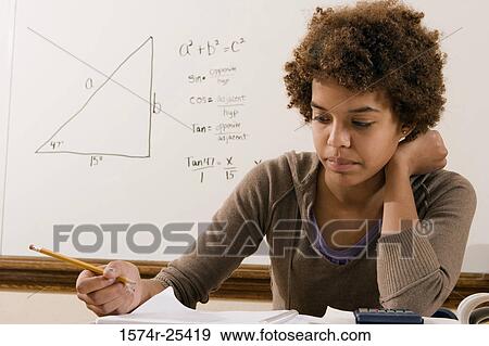 Stock Photo - Student thinking and holding a pencil. Fotosearch