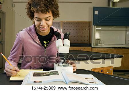 Stock Photo - Student writing in a science lab. Fotosearch