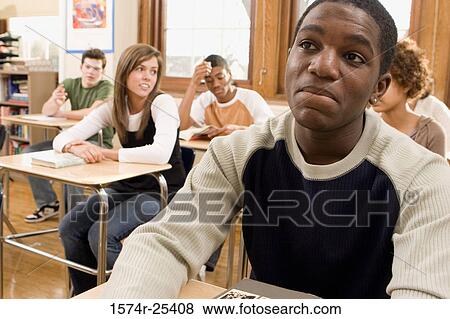 Students sitting at desks in a classroom View Large Photo Image Stock Photo - Students sitting at desks in a classroom. Fotosearch