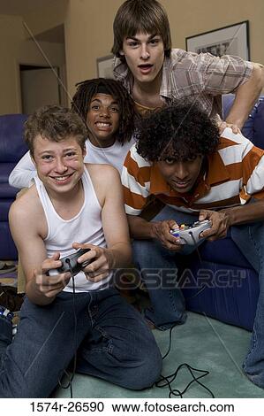 Teenage boy and a young man playing a video game View Large Photo Image Stock Image - Teenage boy and a young man playing a video game. Fotosearch