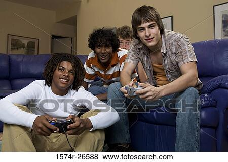Teenage boy and a young man playing a video game View Large Photo Image Stock Photo - Teenage boy and a young man playing a video game. Fotosearch