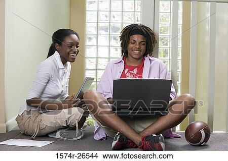 Teenage boy and a young woman using laptops View Large Photo Image Picture - Teenage boy and a young woman using laptops. Fotosearch