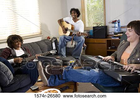 Teenage boy and two young men playing music View Large Photo Image Stock Image - Teenage boy and two young men playing music. Fotosearch