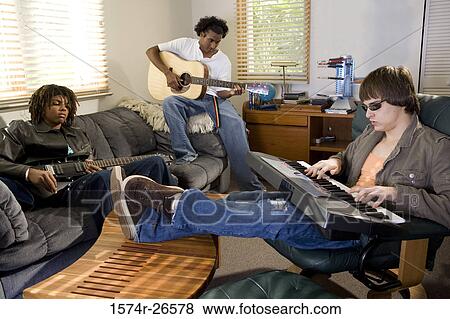 Teenage boy and two young men playing music View Large Photo Image Stock Photo - Teenage boy and two young men playing music. Fotosearch