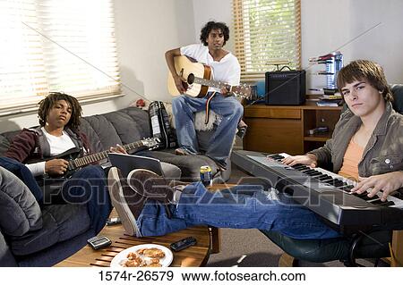 Teenage boy and two young men playing music View Large Photo Image Stock Photo - Teenage boy and two young men playing music. Fotosearch