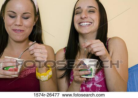 Teenage girl and a young woman eating View Large Photo Image Stock Photo - Teenage girl and a young woman eating. Fotosearch