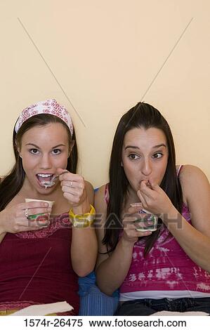 Teenage girl and a young woman eating View Large Photo Image Stock Photography - Teenage girl and a young woman eating. Fotosearch