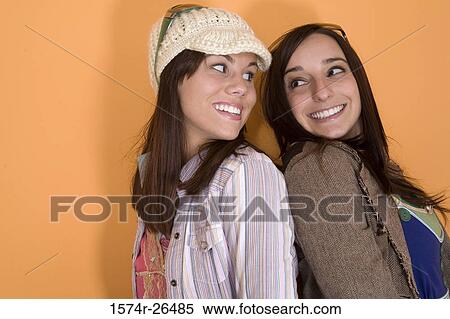 Teenage girl and a young woman looking at each other and smiling View Large Photo Image Stock Photography - Teenage girl and a young woman looking at each other and smiling. Fotosearch