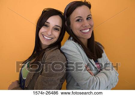 Teenage girl and a young woman smiling View Large Photo Image Stock Photograph - Teenage girl and a young woman smiling. Fotosearch