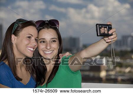 Teenage girl and a young woman photographing themselves View Large Photo Image Stock Photo - Teenage girl and a young woman photographing themselves. Fotosearch