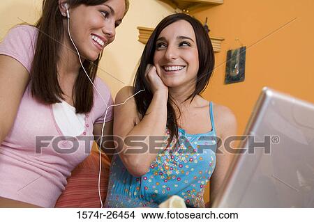 Teenage girl and a young woman using a laptop View Large Photo Image Picture - Teenage girl and a young woman using a laptop. Fotosearch