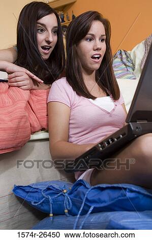 Teenage girl and a young woman using a laptop View Large Photo Image Stock Image - Teenage girl and a young woman using a laptop. Fotosearch