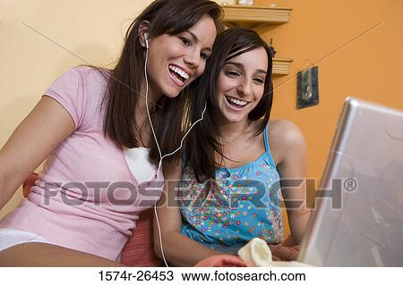 Teenage girl and a young woman using a laptop View Large Photo Image Stock Image - Teenage girl and a young woman using a laptop. Fotosearch