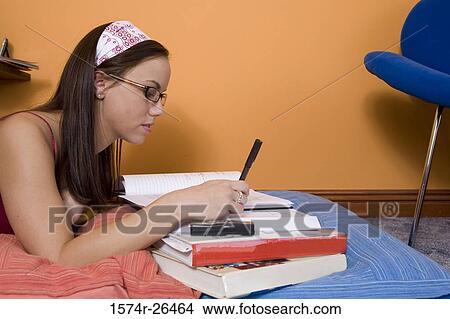 Picture - Teenage girl doing homework. Fotosearch