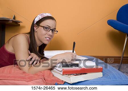 Stock Photography - Teenage girl doing homework. Fotosearch