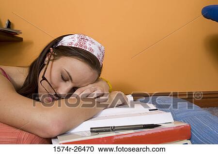 Teenage girl sleeping on textbooks View Large Photo Image Stock Image - Teenage girl sleeping on textbooks. Fotosearch