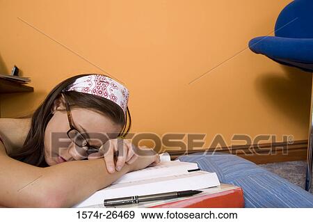 Teenage girl sleeping on textbooks View Large Photo Image Stock Photo - Teenage girl sleeping on textbooks. Fotosearch