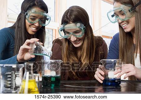 Three students performing an experiment in a science lab View Large Photo Image Stock Image - Three students performing an experiment in a science lab. Fotosearch