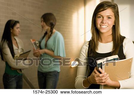 Three students standing in a corridor View Large Photo Image Stock Image - Three students standing in a corridor. Fotosearch