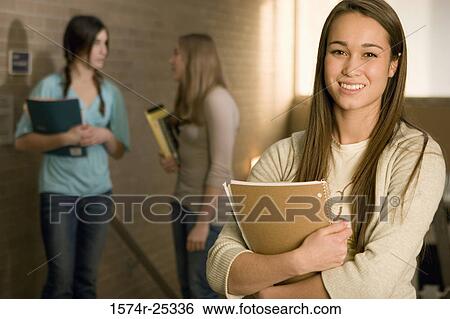 Three students standing in a corridor View Large Photo Image Stock Photograph - Three students standing in a corridor. Fotosearch