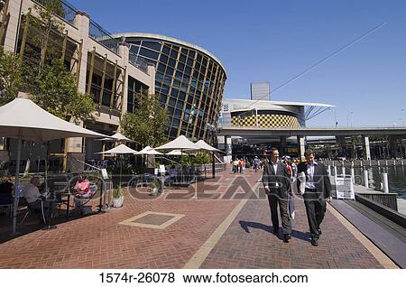 Tourists walking on a walkway at a harbor, Darling Harbor, Sydney, Australia View Large Photo Image Stock Photo - Tourists walking on a walkway at a harbor, Darling Harbor, Sydney, Australia. Fotosearch