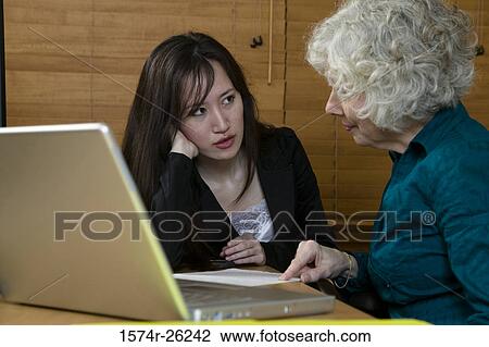 Two businesswomen talking View Large Photo Image Stock Image - Two businesswomen talking. Fotosearch