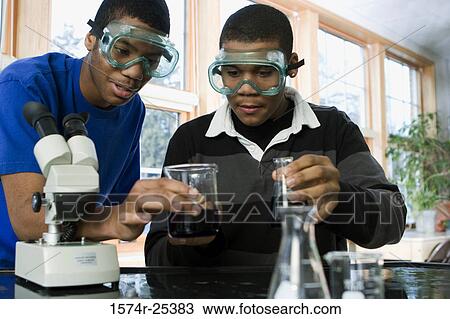 Two student performing an experiment in a science lab View Large Photo Image Stock Image - Two student performing an experiment in a science lab. Fotosearch
