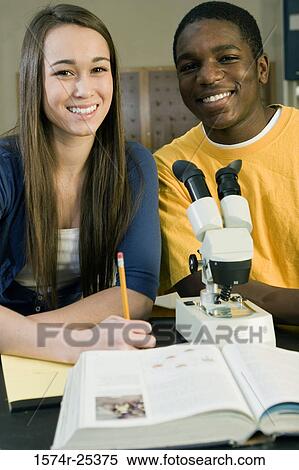 Two students in front of a microscope in a science lab View Large Photo Image Stock Photography - Two students in front of a microscope in a science lab. Fotosearch