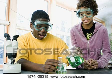 Stock Photography - Two students performing an experiment in a science lab. Fotosearch