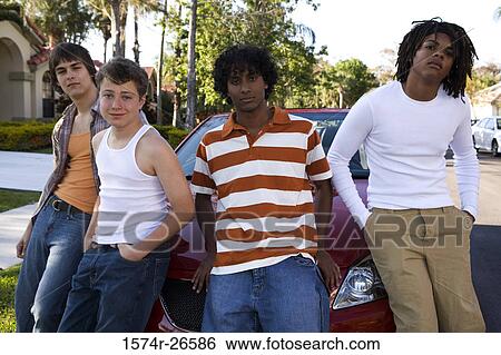 Two teenage boys and two young men leaning against a car View Large Photo Image Stock Photograph - Two teenage boys and two young men leaning against a car. Fotosearch