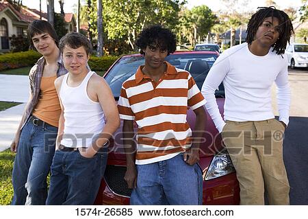 Two teenage boys and two young men leaning against a car View Large Photo Image Stock Photography - Two teenage boys and two young men leaning against a car. Fotosearch