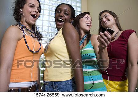 Stock Photo - Two teenage girls and two young women singing. Fotosearch
