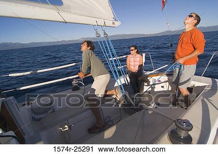 Two young men and a young woman on a sailboat View Large Photo Image Stock Image - Two young men and a young woman on a sailboat. Fotosearch