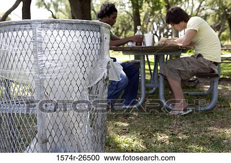 Two young men sitting at a picnic table View Large Photo Image Stock Image - Two young men sitting at a picnic table. Fotosearch