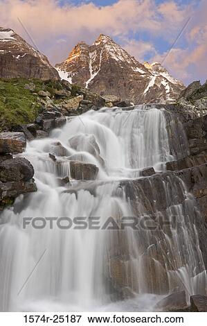 Waterfall in front of a mountain, Lake Oesa, Yoho National Park, British Columbia, Canada View Large Photo Image Stock Photo - Waterfall in front of a mountain, Lake Oesa, Yoho National Park, British Columbia, Canada. Fotosearch