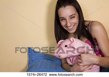 Young woman holding a stuffed animal View Large Photo Image Stock Image - Young woman holding a stuffed animal. Fotosearch