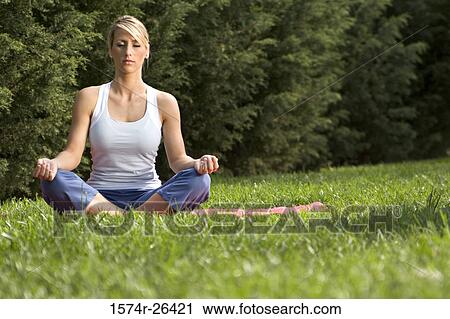 Young woman meditating View Large Photo Image Stock Image - Young woman meditating. Fotosearch