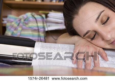 Young woman sleeping on a textbook View Large Photo Image Stock Image - Young woman sleeping on a textbook. Fotosearch