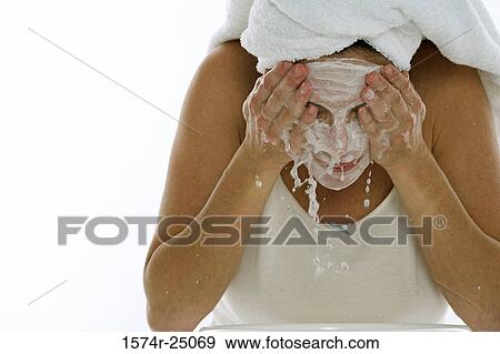 Young woman splashing water on her face View Large Photo Image Stock Photo - Young woman splashing water on her face. Fotosearch