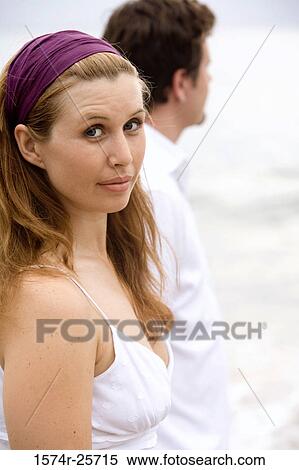 Young woman with a mid adult man standing on the beach View Large Photo Image Stock Photography - Young woman with a mid adult man standing on the beach. Fotosearch