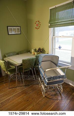 Baby carriage kept by table and chair near window View Large Photo Image Picture - Baby carriage kept by table and chair near window. Fotosearch
